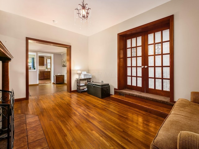 193 W Pearl St, West Jefferson, OH 43162 - living area with french doors, hardwood / wood-style floors, a chandelier, and baseboards