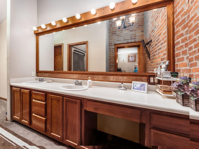 193 W Pearl St, West Jefferson, OH 43162 - full bathroom with double vanity, a chandelier, and brick wall