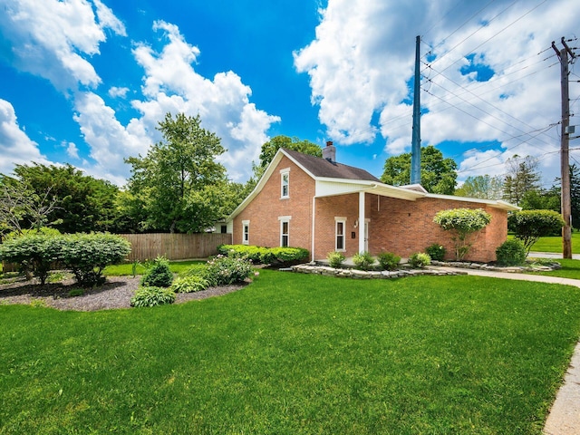 193 W Pearl St, West Jefferson, OH 43162 - view of home's exterior featuring brick siding and a chimney