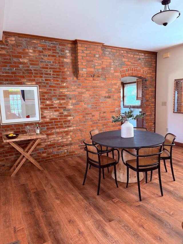41 Hanford St, Columbus, OH 43206 - dining space with wood finished floors, brick wall, and baseboards
