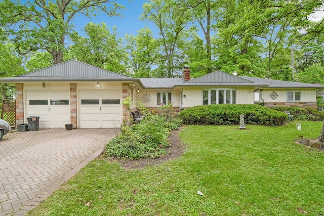 2692 Jordan Rd, Columbus, OH 43231 - ranch-style home featuring a garage, a chimney, decorative driveway, a front lawn, and board and batten siding