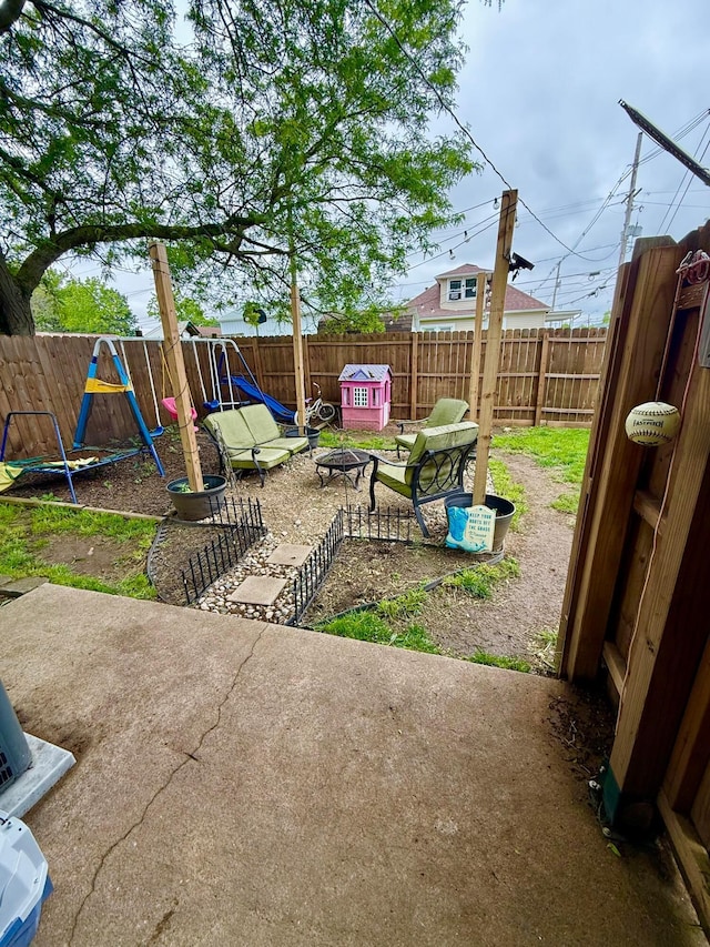 205 Walnut St, Circleville, OH 43113 - fenced backyard featuring a playground and a patio area