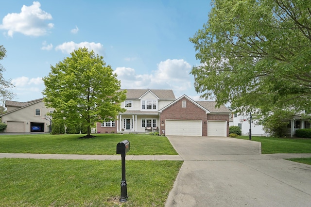 5952 Hampton Cors S, Hilliard, OH 43026 - traditional home with brick siding, a front lawn, concrete driveway, and an attached garage