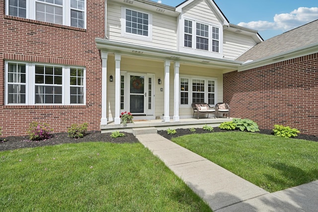 5952 Hampton Cors S, Hilliard, OH 43026 - doorway to property featuring a yard, brick siding, and a porch