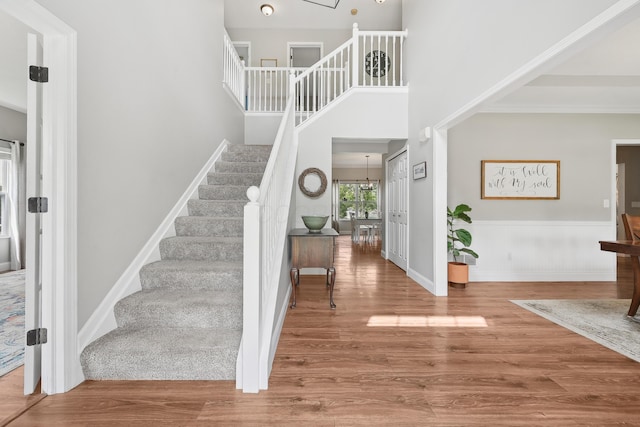 5952 Hampton Cors S, Hilliard, OH 43026 - entrance foyer featuring stairs, wood finished floors, a wainscoted wall, a chandelier, and a towering ceiling
