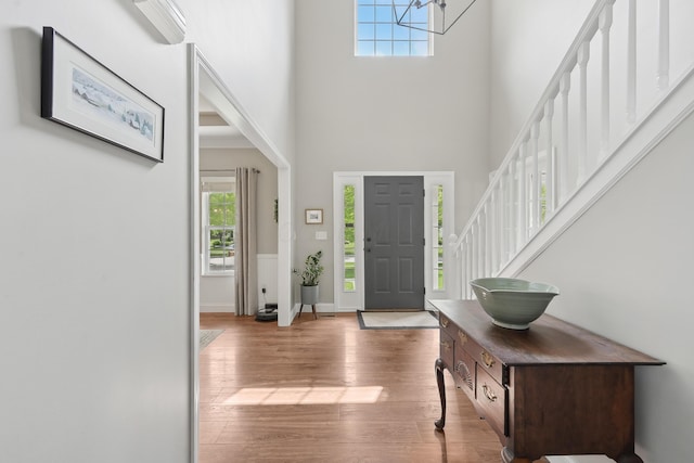 5952 Hampton Cors S, Hilliard, OH 43026 - foyer with a high ceiling, wood finished floors, baseboards, a chandelier, and stairway