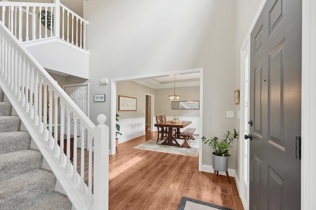 5952 Hampton Cors S, Hilliard, OH 43026 - foyer entrance with a towering ceiling, stairs, light wood-style flooring, baseboards, and crown molding