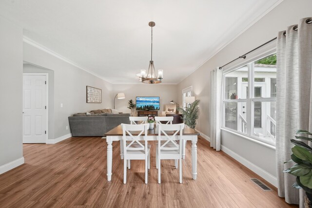 5952 Hampton Cors S, Hilliard, OH 43026 - dining room featuring a chandelier, light wood-type flooring, ornamental molding, and baseboards
