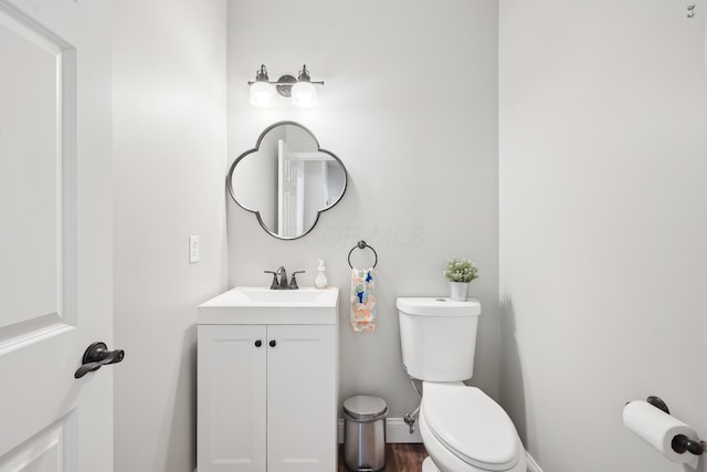 5952 Hampton Cors S, Hilliard, OH 43026 - half bathroom featuring toilet, vanity, and baseboards
