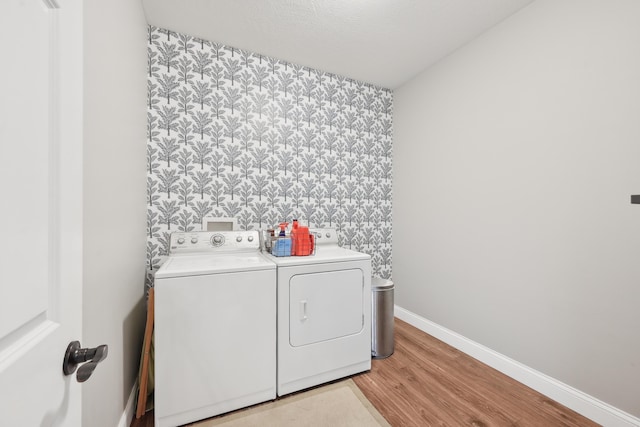 5952 Hampton Cors S, Hilliard, OH 43026 - laundry area with independent washer and dryer, wallpapered walls, light wood-type flooring, baseboards, and an accent wall