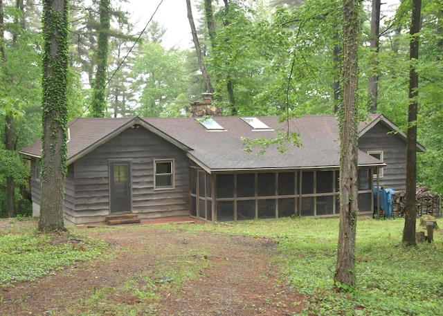 311 Chinook Ln, Sugar Grove, OH 43155 - back of property featuring a sunroom, a shingled roof, a chimney, and entry steps