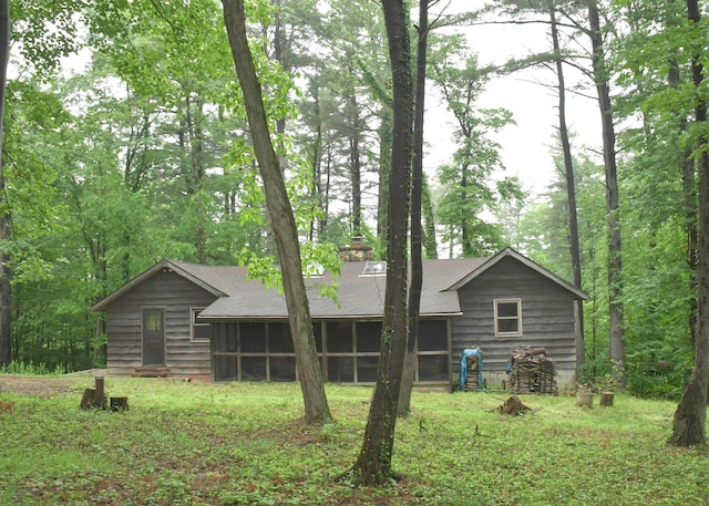 311 Chinook Ln, Sugar Grove, OH 43155 - view of front of house with a sunroom, a chimney, and roof with shingles
