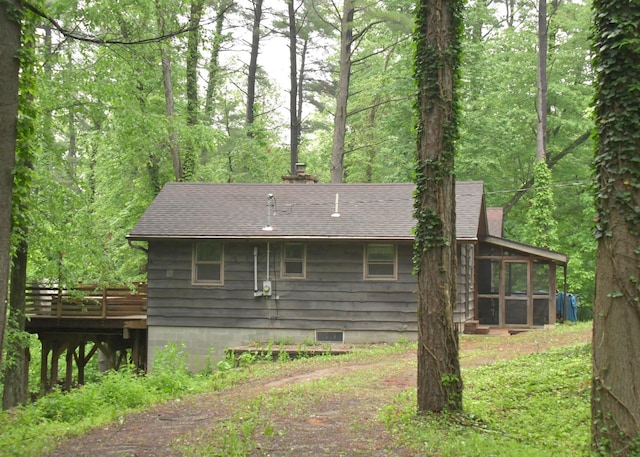 311 Chinook Ln, Sugar Grove, OH 43155 - rear view of property with a deck, roof with shingles, a sunroom, and a wooded view