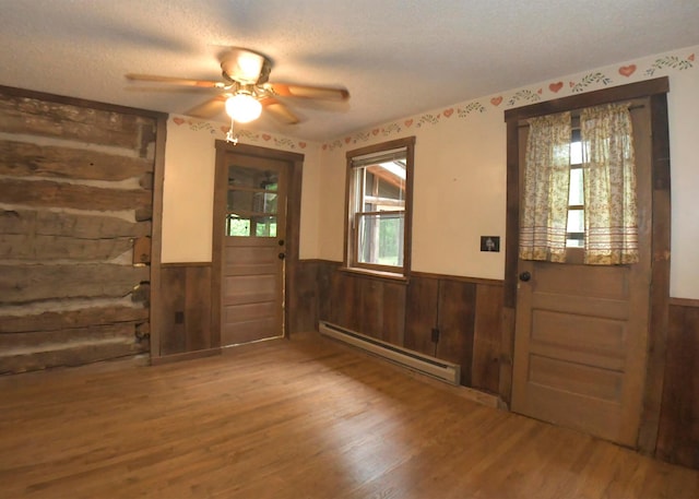 311 Chinook Ln, Sugar Grove, OH 43155 - foyer entrance with baseboard heating, wainscoting, healthy amount of natural light, wood finished floors, and wooden walls