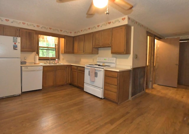 311 Chinook Ln, Sugar Grove, OH 43155 - kitchen with white appliances, a sink, a textured ceiling, wood finished floors, and brown cabinets