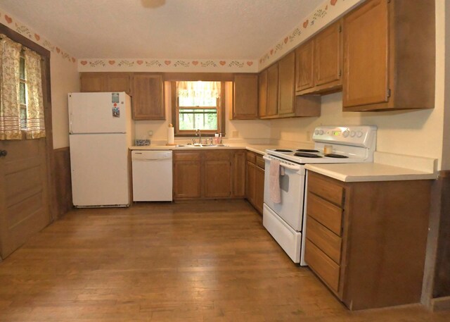 311 Chinook Ln, Sugar Grove, OH 43155 - kitchen with white appliances, a sink, light countertops, light wood-style floors, and brown cabinets