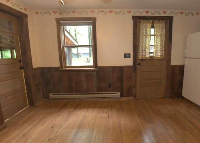 311 Chinook Ln, Sugar Grove, OH 43155 - foyer entrance with baseboard heating, a wainscoted wall, healthy amount of natural light, and hardwood / wood-style flooring