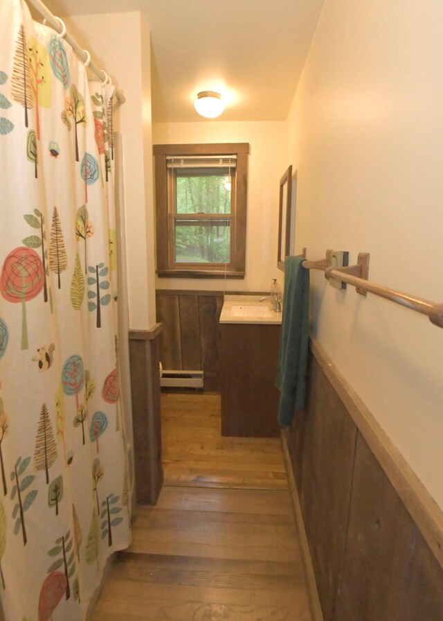 311 Chinook Ln, Sugar Grove, OH 43155 - full bathroom featuring a baseboard radiator, vanity, wood finished floors, and a shower with curtain