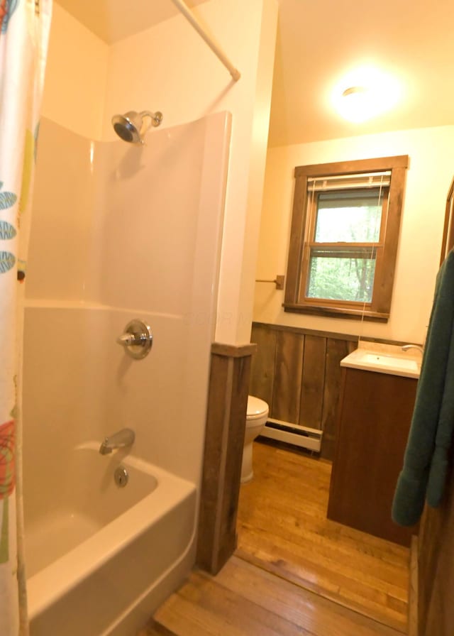 311 Chinook Ln, Sugar Grove, OH 43155 - bathroom with baseboard heating, wood finished floors, toilet, shower / bath combo, and vanity