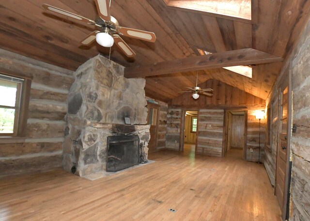 311 Chinook Ln, Sugar Grove, OH 43155 - unfurnished living room featuring hardwood / wood-style flooring, a large fireplace, wooden ceiling, healthy amount of natural light, and a ceiling fan