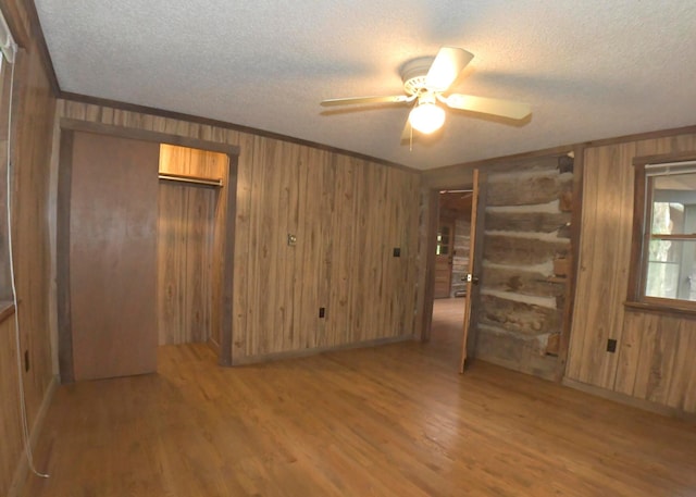 311 Chinook Ln, Sugar Grove, OH 43155 - empty room with a textured ceiling, wood walls, wood finished floors, and ceiling fan