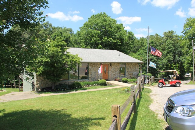 311 Chinook Ln, Sugar Grove, OH 43155 - view of front of house with stone siding, a front yard, and roof with shingles