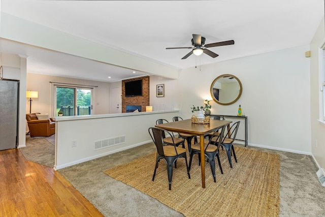 5786 Thompson Rd, Columbus, OH 43230 - dining area with a brick fireplace, ceiling fan, baseboards, wood finished floors, and beamed ceiling