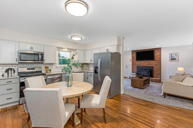 5786 Thompson Rd, Columbus, OH 43230 - dining space featuring wood finished floors and a fireplace
