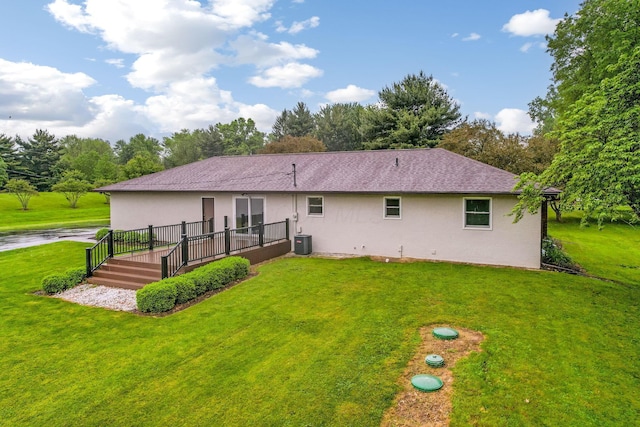 5786 Thompson Rd, Columbus, OH 43230 - back of house with stucco siding, a lawn, a deck, cooling unit, and view of wooded area