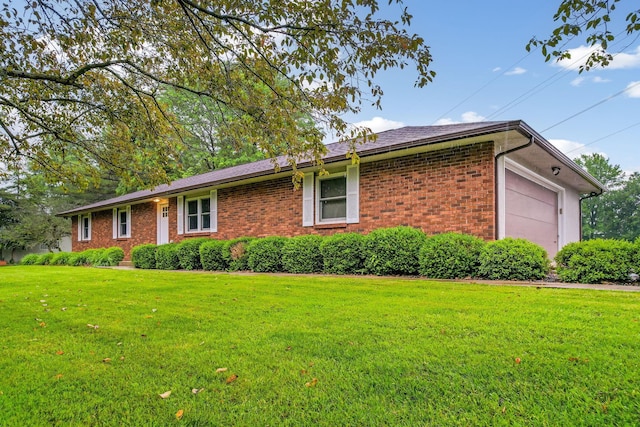 5786 Thompson Rd, Columbus, OH 43230 - ranch-style house featuring brick siding, a front yard, and an attached garage