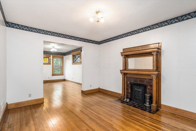 355 W 7th Ave, Columbus, OH 43201 - unfurnished living room featuring wood-type flooring, baseboards, and a tile fireplace