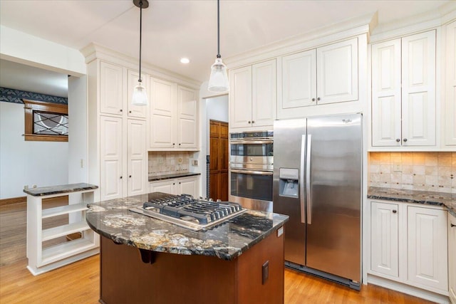 355 W 7th Ave, Columbus, OH 43201 - kitchen with appliances with stainless steel finishes, tasteful backsplash, white cabinetry, light wood-style floors, and dark stone countertops