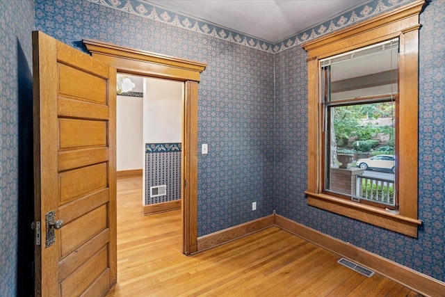 355 W 7th Ave, Columbus, OH 43201 - empty room with wood finished floors, baseboards, and wallpapered walls