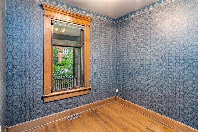 355 W 7th Ave, Columbus, OH 43201 - spare room with wood finished floors, baseboards, and wallpapered walls