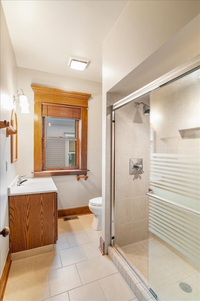 355 W 7th Ave, Columbus, OH 43201 - bathroom with toilet, vanity, a shower stall, baseboards, and tile patterned flooring