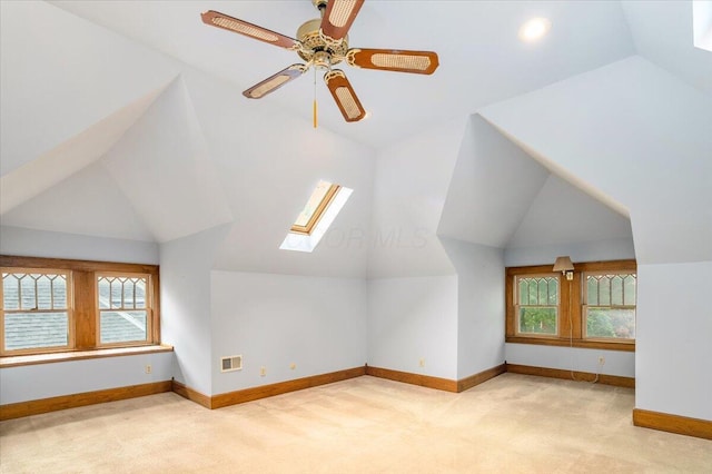 355 W 7th Ave, Columbus, OH 43201 - additional living space featuring lofted ceiling, light colored carpet, a skylight, baseboards, and a ceiling fan