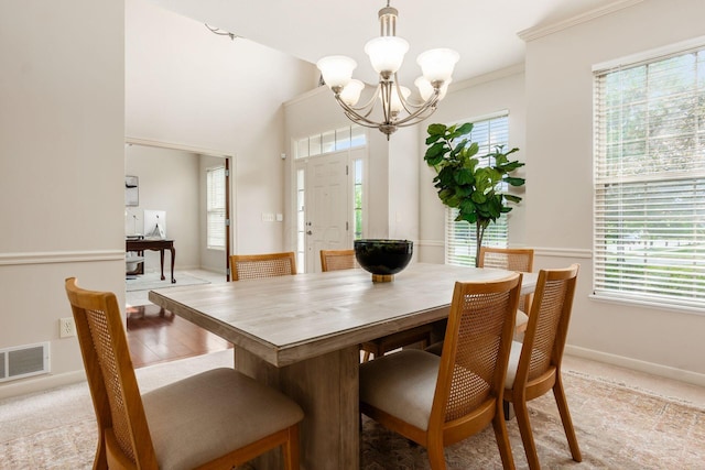 7019 Blakemore Ln, Dublin, OH 43016 - dining space featuring healthy amount of natural light, a chandelier, baseboards, light colored carpet, and ornamental molding