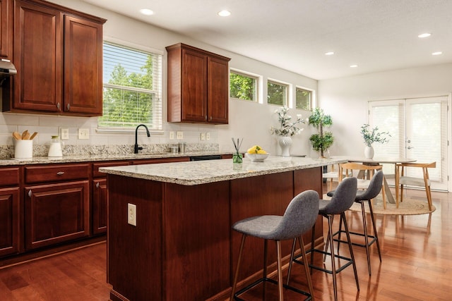 7019 Blakemore Ln, Dublin, OH 43016 - kitchen with recessed lighting, dark wood-style flooring, healthy amount of natural light, and a center island