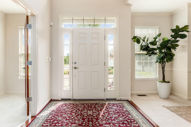 7019 Blakemore Ln, Dublin, OH 43016 - carpeted entrance foyer featuring healthy amount of natural light, baseboards, and ornamental molding