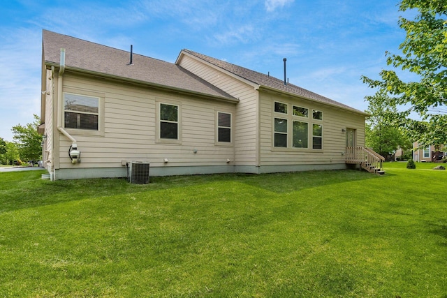 7019 Blakemore Ln, Dublin, OH 43016 - back of house featuring central air condition unit, a lawn, and roof with shingles