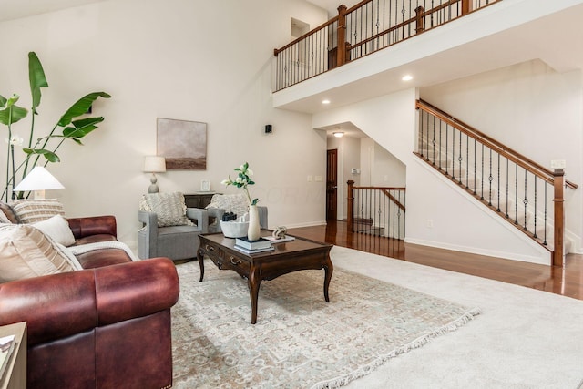 7019 Blakemore Ln, Dublin, OH 43016 - living area featuring wood finished floors, baseboards, a high ceiling, stairway, and recessed lighting