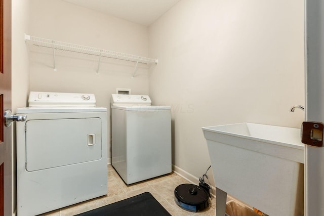 7019 Blakemore Ln, Dublin, OH 43016 - laundry room featuring washing machine and clothes dryer, light tile patterned floors, and baseboards