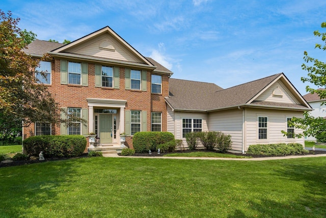 7019 Blakemore Ln, Dublin, OH 43016 - view of front of home with a front lawn, brick siding, and roof with shingles
