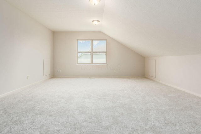 7019 Blakemore Ln, Dublin, OH 43016 - bonus room with vaulted ceiling, light carpet, and baseboards