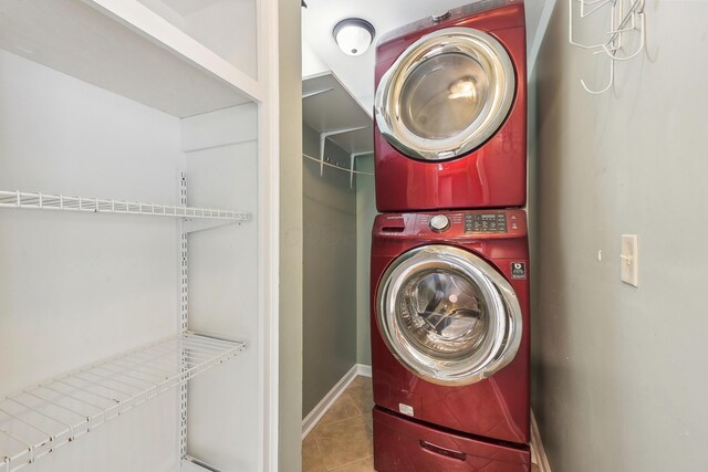 316 Westview Ave, Columbus, OH 43214 - laundry room with stacked washing machine and dryer, tile patterned floors, and baseboards