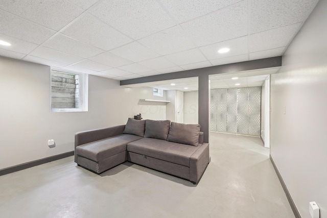316 Westview Ave, Columbus, OH 43214 - living room with finished concrete floors, baseboards, a paneled ceiling, and recessed lighting