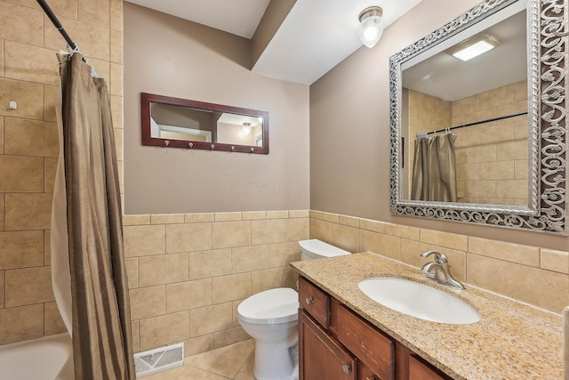 316 Westview Ave, Columbus, OH 43214 - full bathroom featuring tile walls, toilet, vanity, shower / tub combo with curtain, and tile patterned flooring