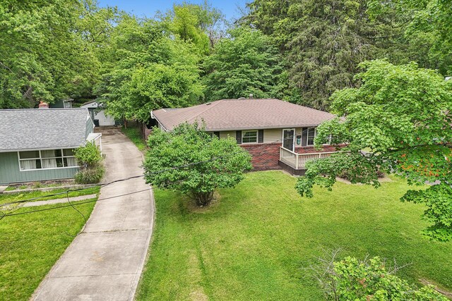 316 Westview Ave, Columbus, OH 43214 - ranch-style home with concrete driveway, roof with shingles, a front lawn, and a wooden deck