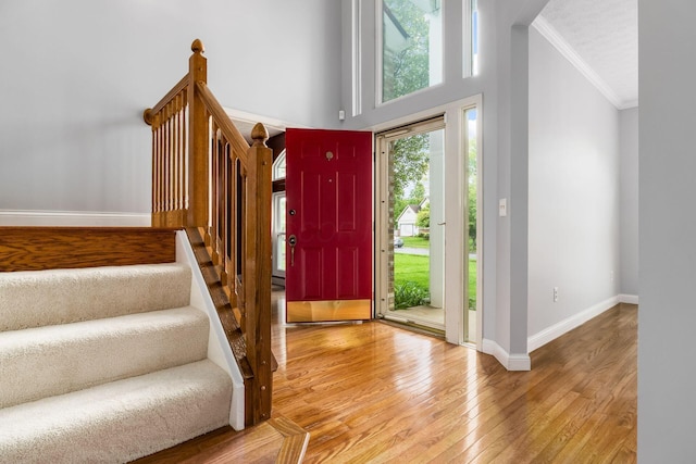 544 Courtright Ct, Pickerington, OH 43147 - foyer entrance with crown molding, baseboards, hardwood / wood-style flooring, stairs, and a towering ceiling