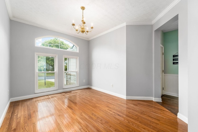 544 Courtright Ct, Pickerington, OH 43147 - unfurnished room with wood-type flooring, a chandelier, crown molding, a textured ceiling, and baseboards